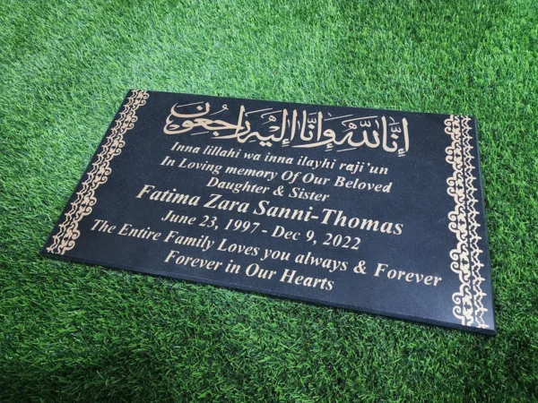 black granite islamic gravestone with golden inscription