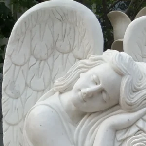 white marble headstone with angel sculptured